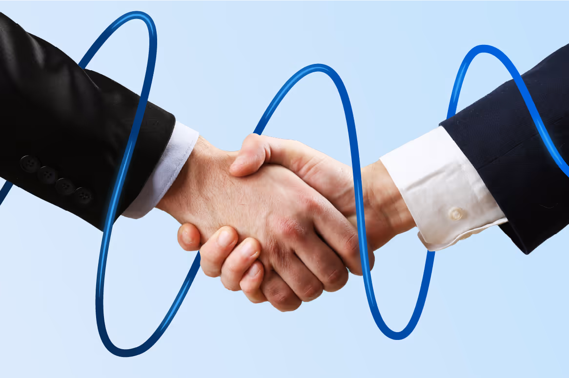 Two hands shaking in a business handshake with blue circular rings around them.